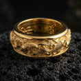Load image into Gallery viewer, Koi fish sterling silver band ring on black volcanic stone, shown in a gold plated finish that adds warm shine while keeping the koi relief crisp.