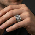 Load image into Gallery viewer, Sterling silver Masonic square and compass band ring worn on a finger, polished silver look with a clean reflective surface and defined emblem edges.