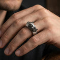 Load image into Gallery viewer, Sterling silver rhino head ring worn on a finger, oxidized finish adding bold contrast to the rhino head relief for a rugged statement look.