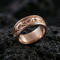 Load image into Gallery viewer, Sterling silver band ring photographed on black volcanic stone, shown in a rose gold plated finish with soft warm reflections emphasizing the engraved monkey motif.