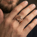 Load image into Gallery viewer, Rose gold plated Freemason signet ring on a finger, close-up lifestyle photo showcasing warm finish and detailed square and compass design