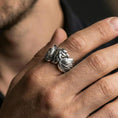 Load image into Gallery viewer, Eagle head and wing sterling silver ring worn on a finger, polished silver finish with a clean shine and crisp feather definition.