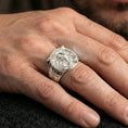 Load image into Gallery viewer, Polished silver Norse warrior ring on the finger, wearable shot highlighting the shield face, skull helmet relief and engraved axe details