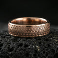 Load image into Gallery viewer, Rose gold plated sterling silver band on volcanic stone, intricate repeating geometric texture, minimal high-end close-up.