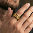 Load image into Gallery viewer, Gold plated lion medallion band worn on finger, bold lion relief with decorative arches, premium lifestyle jewelry photo.