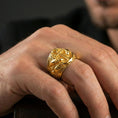 Load image into Gallery viewer, Gold plated anchor ring with shark accents worn on a finger, lifestyle image showing bold marine-themed statement look