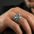 Load image into Gallery viewer, Oxidized anchor and shark ring worn on a finger, close-up lifestyle shot highlighting deep relief and nautical statement style