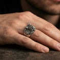 Load image into Gallery viewer, Oxidized Oni mask ring worn on a finger, close-up lifestyle photo highlighting the horned demon face and deep relief details