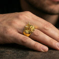 Load image into Gallery viewer, Gold plated Oni mask ring worn on a finger, lifestyle image focusing on the raised demon face and engraved side motifs