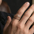 Load image into Gallery viewer, Rose gold plated fleur-de-lis ring on a finger, lifestyle photo emphasizing the vintage fleur-de-lis crest and engraved leaves
