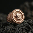 Load image into Gallery viewer, Rose gold plated Greek coin ring with helmeted warrior portrait and rope bezel detail, close-up photo on volcanic rock