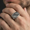 Load image into Gallery viewer, Oxidized Archangel Michael ring worn on a finger, lifestyle close-up highlighting the MDXI detail and engraved side lettering