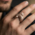 Load image into Gallery viewer, Rose gold plated wing open band ring on the finger, lifestyle shot showcasing the feathered wing silhouette and sculpted head detail