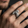 Load image into Gallery viewer, Oxidized eagle wing open ring worn on a finger, lifestyle close-up highlighting feather layering and sculpted bird head
