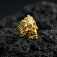 Load image into Gallery viewer, Gold plated woodgrain skull ring with carved bark texture and engraved band accents, product-only macro image on volcanic rock
