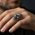 Load image into Gallery viewer, Oxidized bearded skull ring worn on a finger, lifestyle close-up highlighting gothic texture and sculpted beard detail