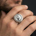 Load image into Gallery viewer, Polished silver ancient coin ring on the finger, wearable close-up focusing on the emperor-style profile and textured coin detail