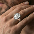 Load image into Gallery viewer, Polished silver ancient coin signet ring on the finger, wearable close-up focusing on the round bezel and portrait details