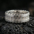 Load image into Gallery viewer, Polished silver industrial railway band ring on black volcanic stone, crisp rivet detailing and vertical track pattern, centered close-up studio lighting.