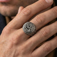 Load image into Gallery viewer, Oxidized all-seeing eye triangle ring worn on a finger, close-up lifestyle photo highlighting the engraved Latin motto