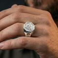 Load image into Gallery viewer, Polished silver finish Valknut signet ring on the finger, macro lifestyle image highlighting the geometric octagon face and Viking emblem details