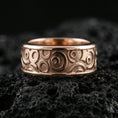 Load image into Gallery viewer, Rose gold plated sterling silver circle pattern spinner band on volcanic stone, bold circular relief with deep contrast, minimal high-end close-up.