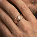 Load image into Gallery viewer, Rose gold plated lion spinner band ring worn on finger, sculpted lion scene relief with textured edges, elegant lifestyle wear shot.