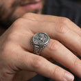 Load image into Gallery viewer, Oxidized finish US eagle seal signet ring worn on a finger, close-up lifestyle shot highlighting the engraved emblem and bold signet profile