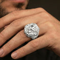 Load image into Gallery viewer, Polished silver finish skull and eagle ring on the finger, macro lifestyle image emphasizing the crisp eagle wing engraving and skull depth