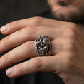 Load image into Gallery viewer, Oxidized sterling silver steampunk skull ring worn on finger, goggles and mechanical detail, natural lifestyle hand shot with shallow depth of field.