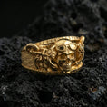 Load image into Gallery viewer, Gold plated steampunk skull ring on volcanic rock, detailed goggles and industrial hardware accents, luxury jewelry product photography.
