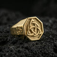 Load image into Gallery viewer, Sterling silver triquetra signet ring with a gold plated finish, raised Celtic knot on octagonal signet face, macro on volcanic rock