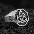 Load image into Gallery viewer, Sterling silver triquetra signet ring with an oxidized finish, octagonal face and Celtic knot symbol, macro on black volcanic rock