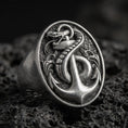 Load image into Gallery viewer, Sterling silver anchor and snake signet ring with an oxidized finish, nautical serpent emblem in high relief, macro on black volcanic rock