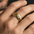 Load image into Gallery viewer, Gold plated floral scroll band worn on finger, detailed flower motif and elegant leaf engraving, premium lifestyle jewelry photo.