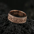 Load image into Gallery viewer, Rose gold plated sterling silver filigree scroll band on volcanic stone, intricate swirl engraving with deep contrast and dotted borders, minimal high-end close-up.