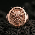 Load image into Gallery viewer, Rose gold plated Japanese demon signet ring on porous volcanic rock, premium lighting emphasizing depth and contrast