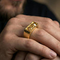 Load image into Gallery viewer, Gold plated finish sterling silver rectangular signet ring worn on a finger, close-up lifestyle photo emphasizing the geometric face and skull detail