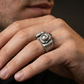 Load image into Gallery viewer, Oxidized finish sterling silver camera signet ring worn on a finger, close-up lifestyle shot highlighting the 3D lens and vintage patina