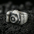 Load image into Gallery viewer, Sterling silver camera signet ring with an oxidized finish, 3D vintage camera design with lens detail, macro on black volcanic rock