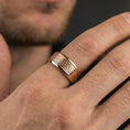 Load image into Gallery viewer, Rose gold plated Greek key band ring worn on finger, clean geometric meander engraving, elegant lifestyle wear shot.