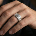 Load image into Gallery viewer, Polished silver Maltese cross fidget spinner ring on finger, crisp cross relief with ornate panel detail, refined everyday wear close-up.