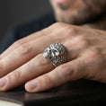 Load image into Gallery viewer, Polished silver finish masonic skull ring on the finger, macro lifestyle image focusing on the skull relief and ornate gothic side engravings