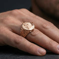 Load image into Gallery viewer, Sterling silver eye pyramid statement ring on a finger, macro lifestyle shot featuring the rose gold plated finish and symbolic engraved ray pattern