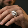 Load image into Gallery viewer, Sterling silver ancient Greek soldier ring on a finger, macro lifestyle image emphasizing the polished silver finish and sculptural warrior figures