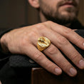 Load image into Gallery viewer, Sterling silver pharaoh head ring worn on a finger, close-up lifestyle photo showcasing the gold plated finish and bold oval signet profile