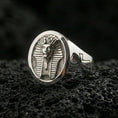 Load image into Gallery viewer, Sterling silver pharaoh ring in a polished silver finish, oval signet design with detailed Egyptian headpiece relief and engraved ankh shoulder accent, close-up on volcanic stone