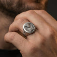 Load image into Gallery viewer, Sterling silver Egyptian pharaoh signet ring worn on a finger, close-up lifestyle shot highlighting the oxidized oval face and carved ankh side detail