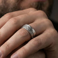 Load image into Gallery viewer, Oxidized sterling silver Grand Teton mountain band worn on finger, alpine skyline engraving detail, natural lifestyle hand shot with shallow depth of field.