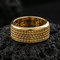 Load image into Gallery viewer, Gold plated scale texture band ring on volcanic rock, detailed repeating scale pattern with clean borders, luxury jewelry product photography.